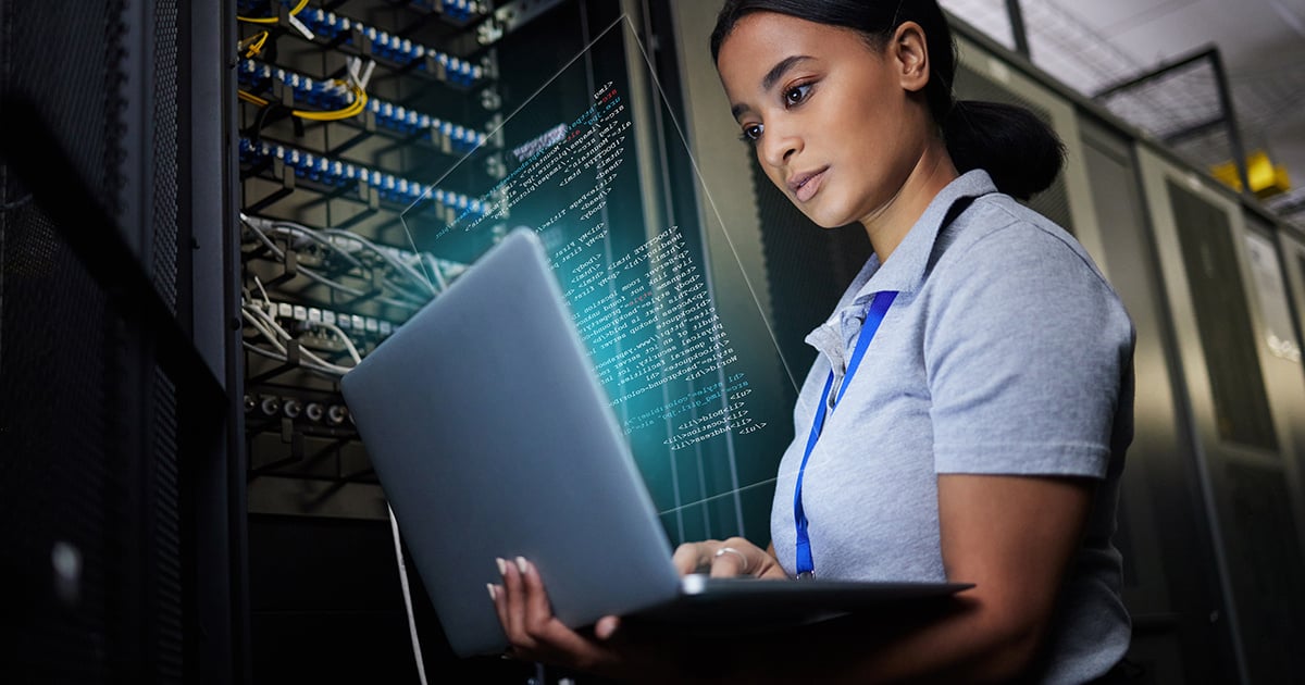 female it support engineer working in a server room